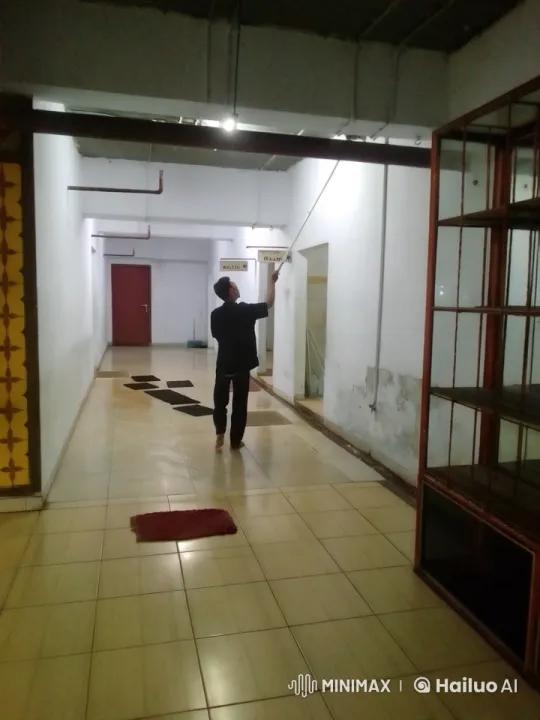 Man Adjusts Ceiling in Dimly Lit Corridor – AI Generated Video | Hailuo AI