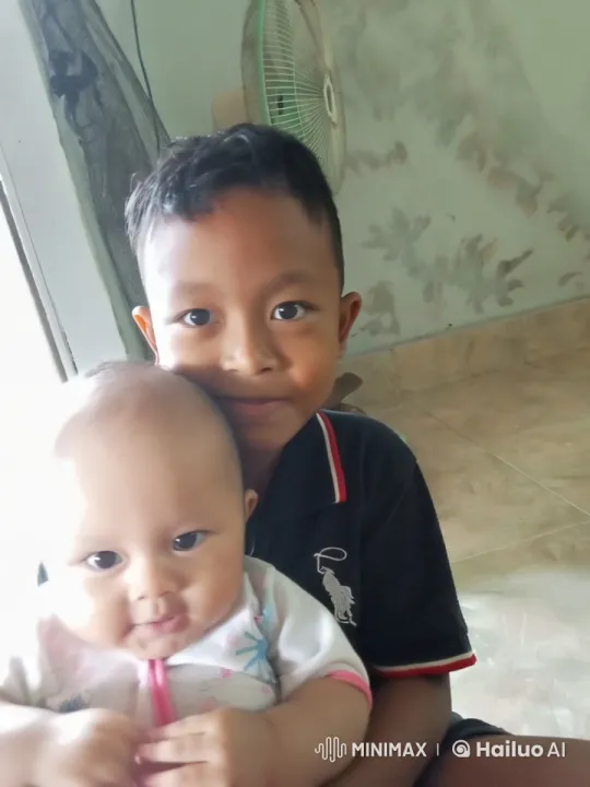 Young Boy and Baby Bond in Cozy Indoor Scene – AI Generated Video | Hailuo AI