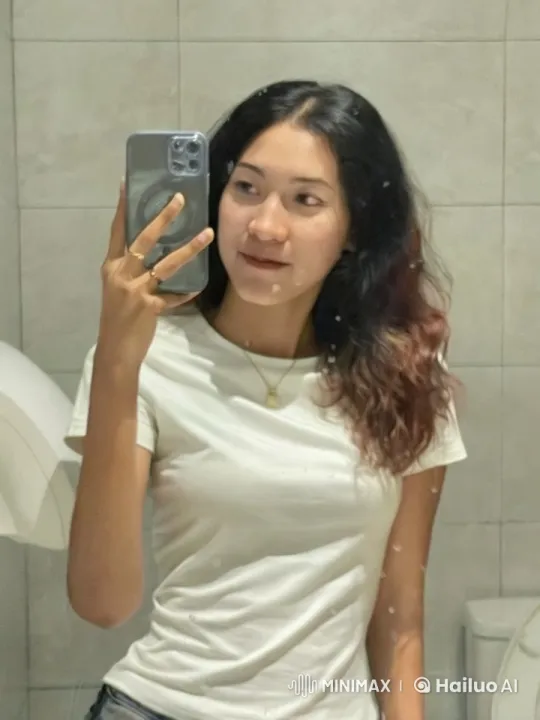 Young Woman Taking Mirror Selfie in Bathroom – AI Generated Video | Hailuo AI