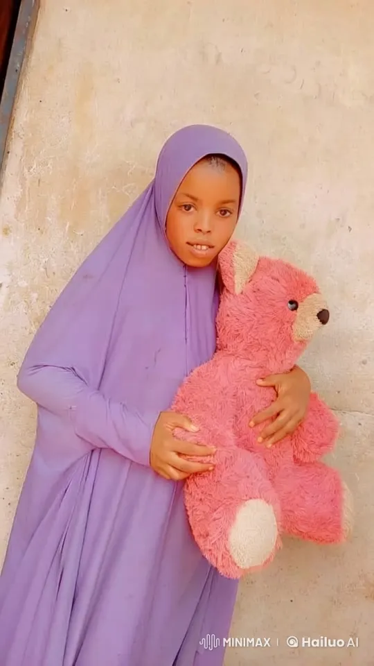 Person Cuddles Pink Teddy Bear Against Beige Wall – AI Generated Video | Hailuo AI