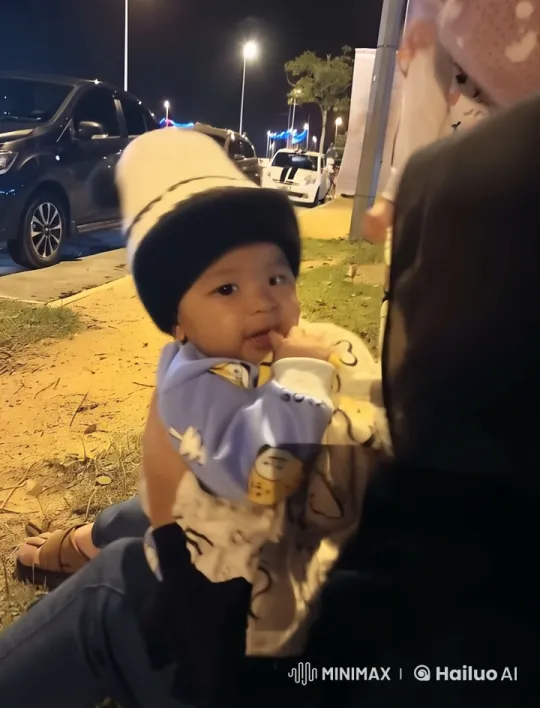 Child Enjoying Night Out on Adult's Lap – AI Generated Video | Hailuo AI