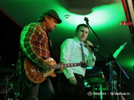 Live Performance: Vocalist and Guitarist in Green-Lit Stage – AI Generated Video | Hailuo AI