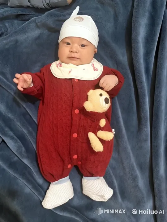 Baby in Red Onesie with Animated Teddy Bear on Soft Blanket – AI Generated Video | Hailuo AI