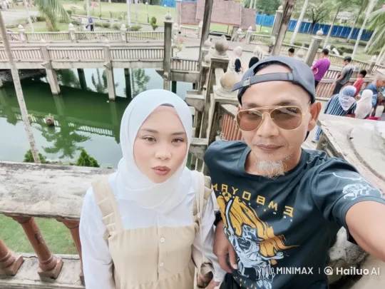 Couple Taking Selfie at Scenic Wooden Bridge – AI Generated Video | Hailuo AI