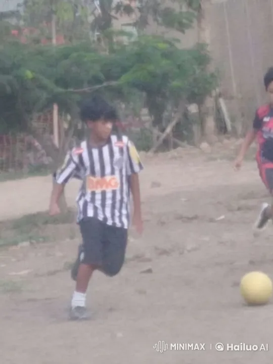 Young Boy Dribbles Soccer Ball Skillfully on Dirt Field – AI Generated Video | Hailuo AI