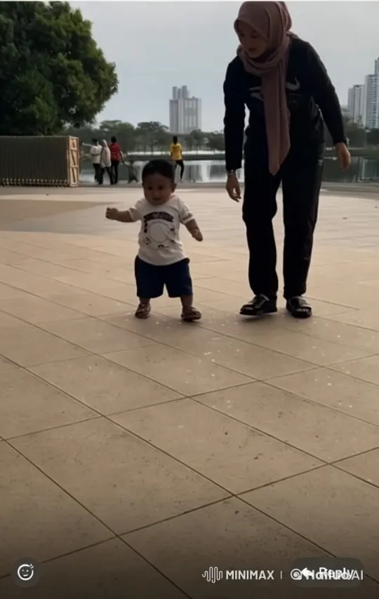 Child and Adult Engage in Playful Kungfu Stance in Park – AI Generated Video | Hailuo AI