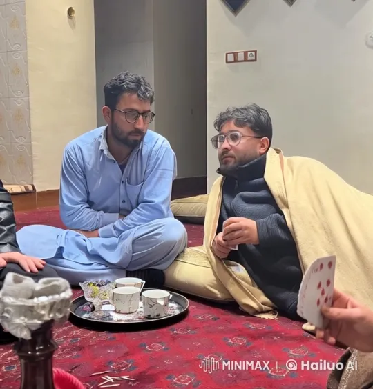 Intimate Moment of Two Men Sharing Cards and Tea – AI Generated Video | Hailuo AI