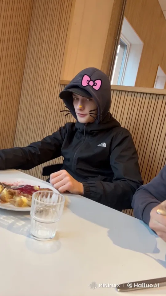 Young Man in North Face Jacket Kisses Partner in Restaurant – AI Generated Video | Hailuo AI