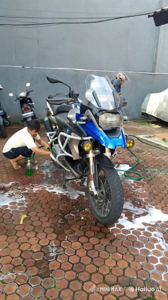 Person Washing Blue and Black Motorcycle with Soap – AI Generated Video | Hailuo AI