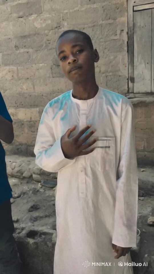 Traditional Figure in Respectful Pose Against Rustic Wall – AI Generated Video | Hailuo AI
