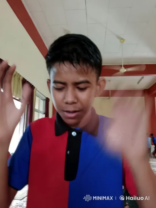 Close-up of Person in Red and Blue Shirt Indoors – AI Generated Video | Hailuo AI