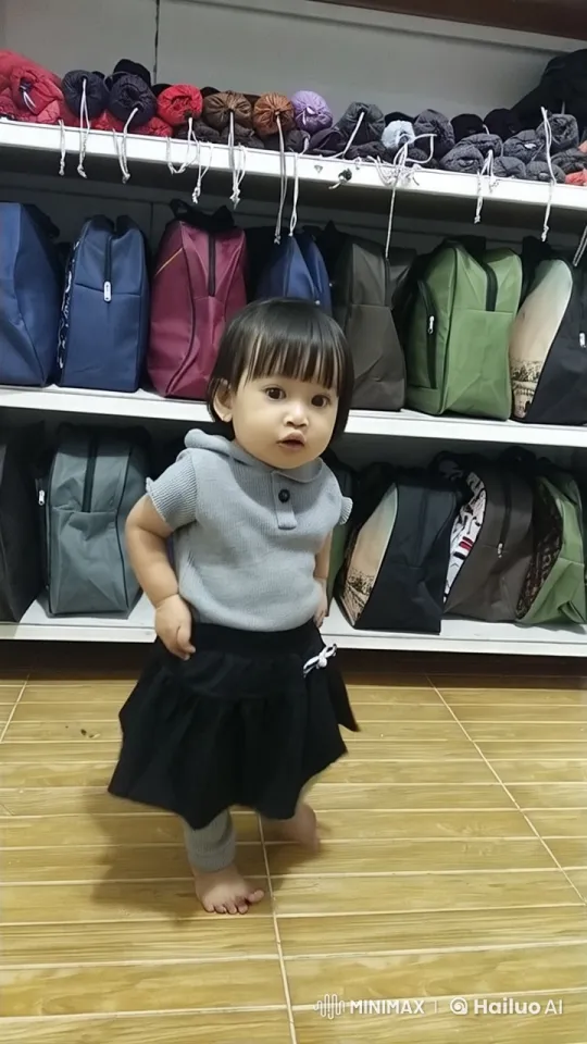 Cute Child Practicing Kung Fu in Front of Colorful Bags – AI Generated Video | Hailuo AI
