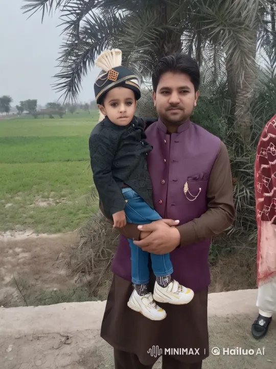 Traditional Man and Boy Playfully Interact in Serene Countryside – AI Generated Video | Hailuo AI