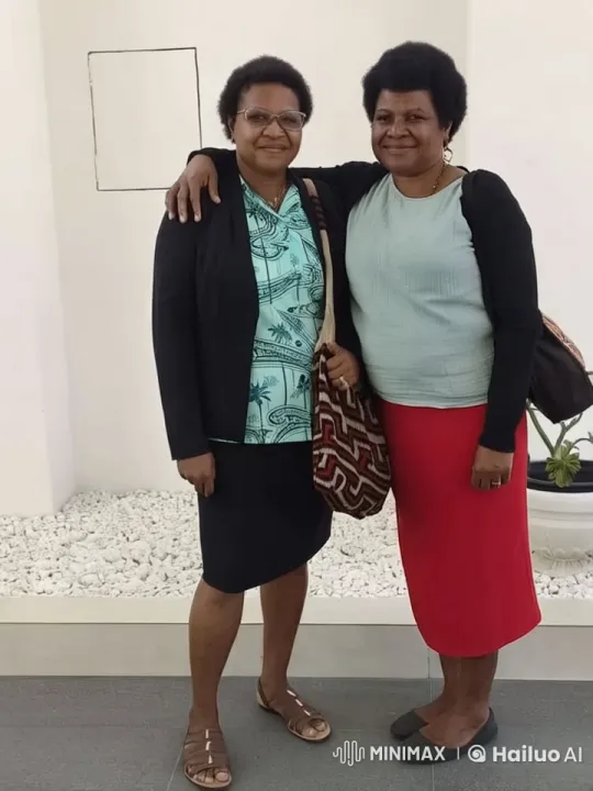 Two Women Pose with Bags in Indoor Setting – AI Generated Video | Hailuo AI