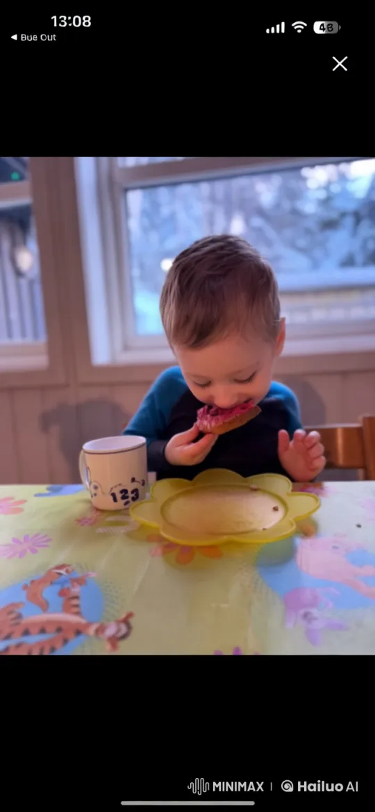 Child Enjoying Bread at Cozy Winter Table – AI Generated Video | Hailuo AI