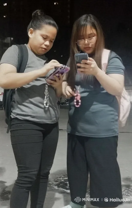 Two Women Engaging with Phones at Night – AI Generated Video | Hailuo AI