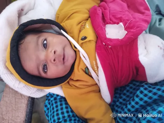 Crying Baby in Yellow Outfit with Red Blanket – AI Generated Video | Hailuo AI