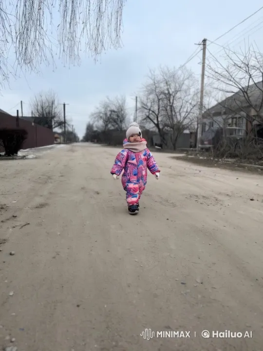 Winter Walk: Girl in Snowsuit Amid Falling Flakes – AI Generated Video | Hailuo AI