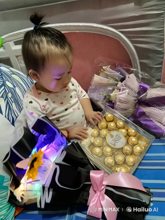 Child Joyfully Eats Chocolate on a Bed Full of Gifts – AI Generated Video | Hailuo AI