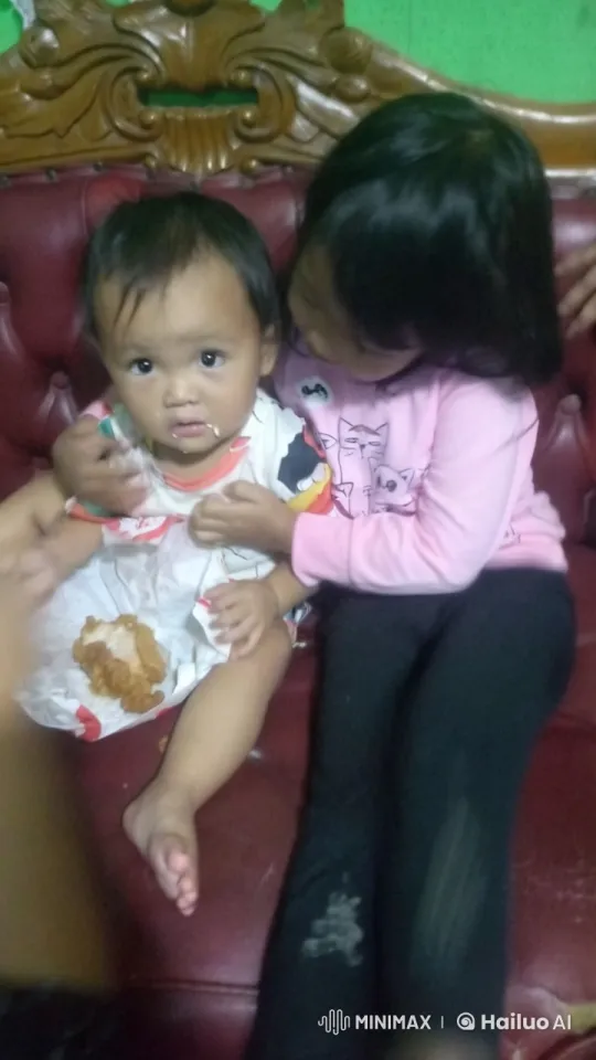 Sibling Play: Gentle Punches and Kicks in Red Chair – AI Generated Video | Hailuo AI