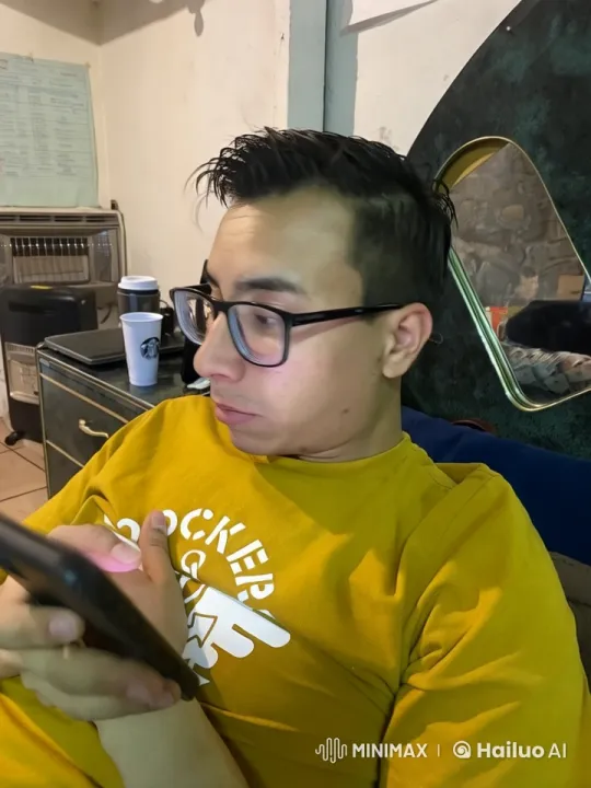 Cozy Room: Person Relaxing on Couch, Engaged with Smartphone – AI Generated Video | Hailuo AI