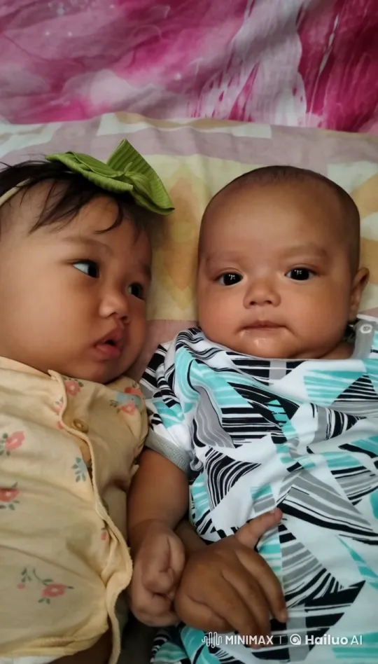 Peaceful Moment: Two Infants Resting on Colorful Bedspread – AI Generated Video | Hailuo AI
