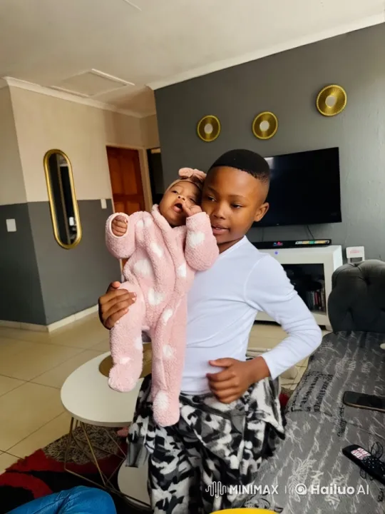 Young Boy Practicing Kung Fu with Baby in Cozy Room – AI Generated Video | Hailuo AI