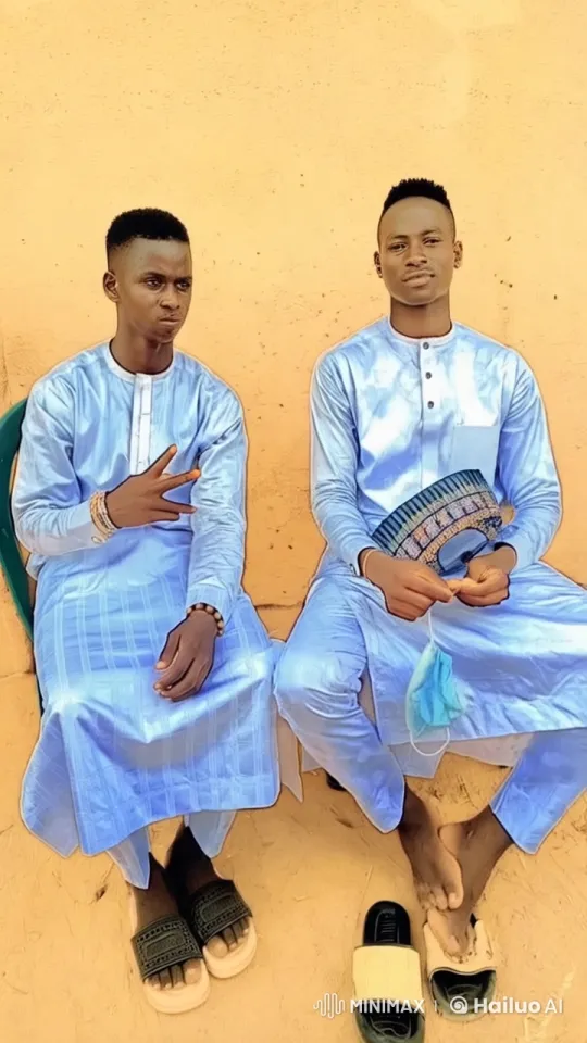 Two Young Men in Traditional Attire Displaying Friendship – AI Generated Video | Hailuo AI