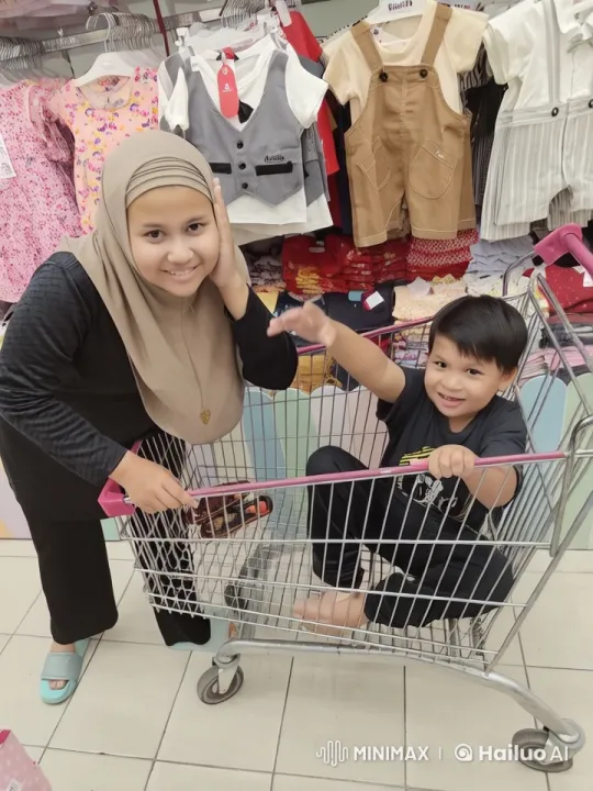 Boy Practices Kungfu in Shopping Cart Amidst Children's Clothing – AI Generated Video | Hailuo AI
