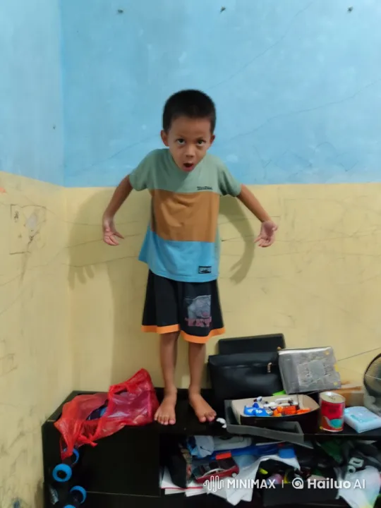 Boy with Animated Flames Stands Confidently in Cluttered Room – AI Generated Video | Hailuo AI