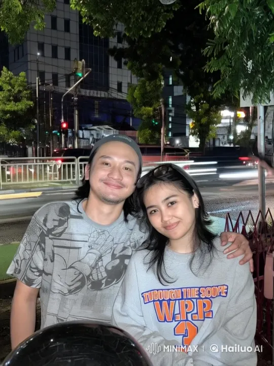 Couple Poses for Picture Amidst Animated City Nightlife – AI Generated Video | Hailuo AI