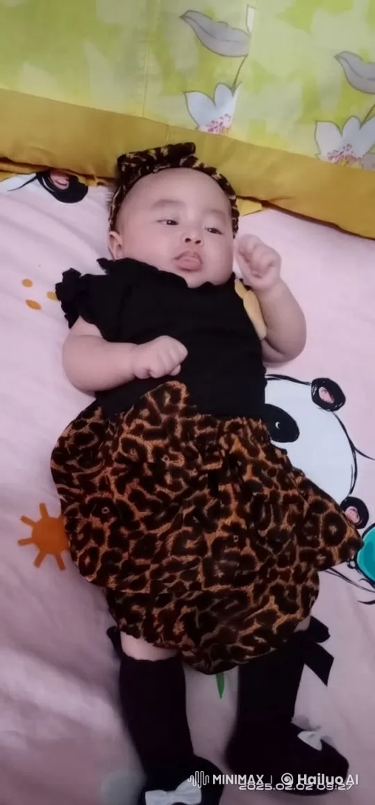Baby in Black Top and Leopard Skirt on Colorful Bed – AI Generated Video | Hailuo AI