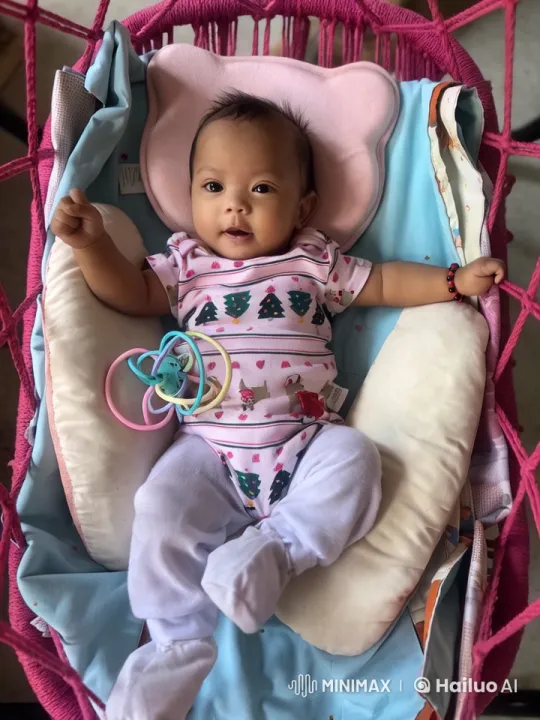 Baby in Christmas Onesie Joyfully Swings in Hammock – AI Generated Video | Hailuo AI