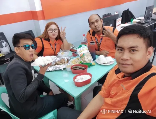 Colleagues Share Meal in Lively Office Setting – AI Generated Video | Hailuo AI