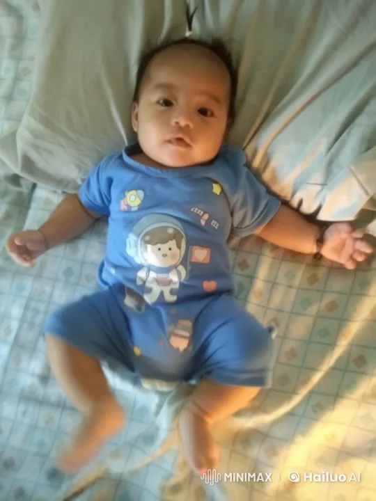 Baby Dancing Playfully in Space-Themed Outfit on Bed – AI Generated Video | Hailuo AI