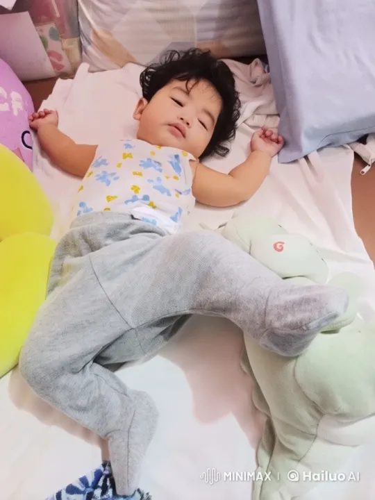Baby Sleeping Peacefully Amidst Pillows and Toys – AI Generated Video | Hailuo AI