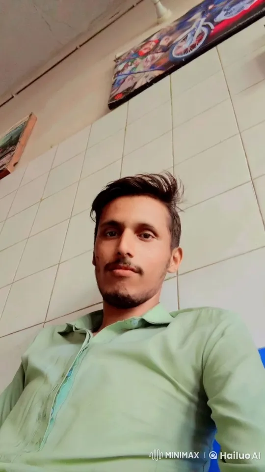 Person Sitting Against Tiled Wall with Posters – AI Generated Video | Hailuo AI