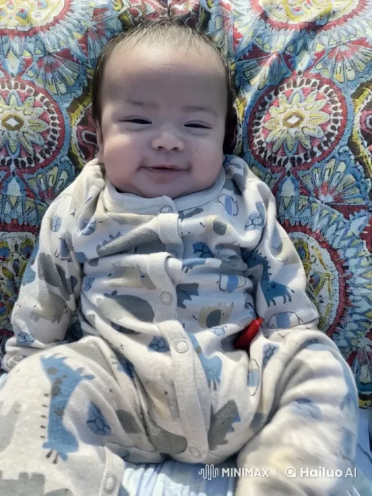 Baby Dances Joyfully in Dinosaur Onesie on Colorful Blanket – AI Generated Video | Hailuo AI