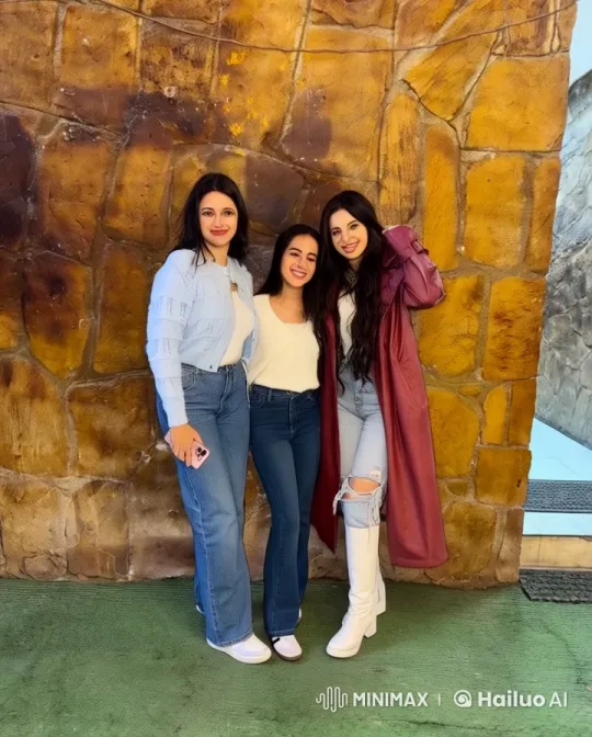 Three Women in Casual Attire by a Rustic Stone Wall – AI Generated Video | Hailuo AI