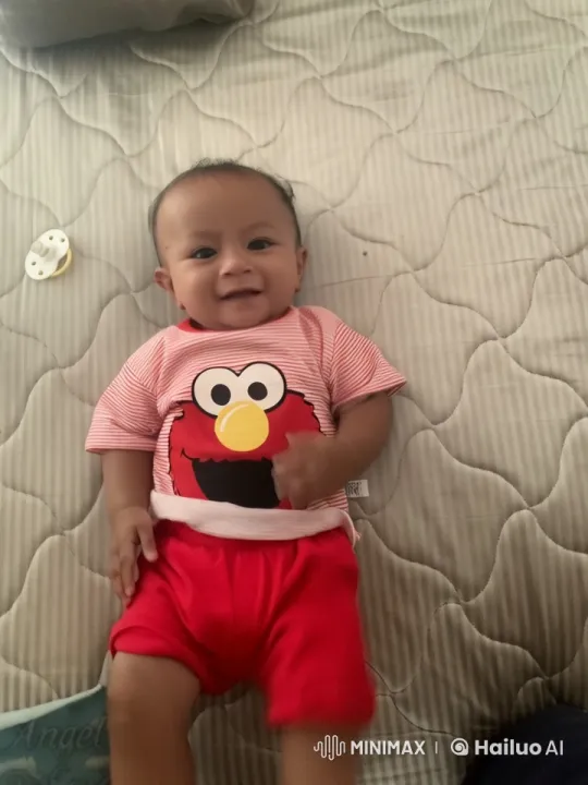 Baby Dances and Plays in Elmo Outfit on Quilted Bed – AI Generated Video | Hailuo AI