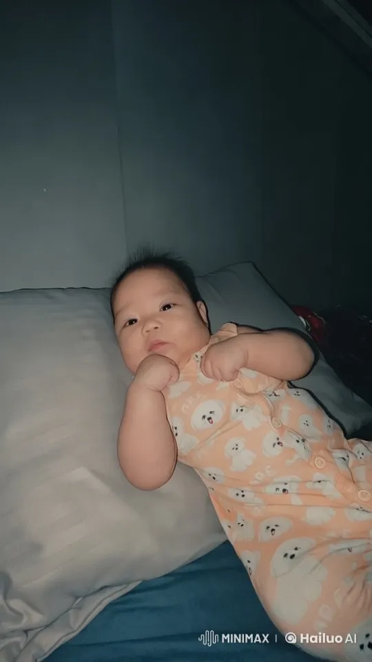 Baby Dancing Joyfully in Peach Onesie on Bed – AI Generated Video | Hailuo AI