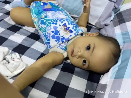 Baby's Playful Actions on Checkered Bed – AI Generated Video | Hailuo AI