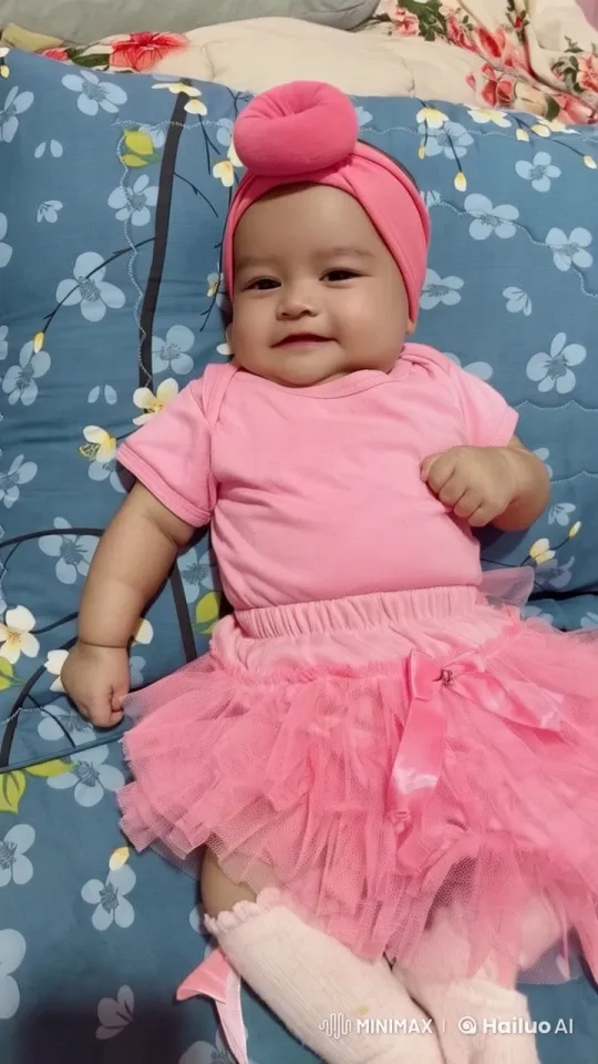 Baby Dances Joyfully in Pink Outfit on Floral Cushion – AI Generated Video | Hailuo AI