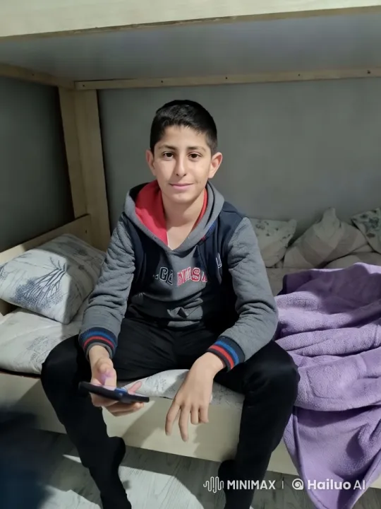 Young Man Relaxing with Smartphone in Cozy Room – AI Generated Video | Hailuo AI