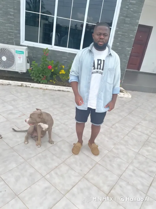 Man and Dog Playfully Spar in Modern Patio Setting – AI Generated Video | Hailuo AI