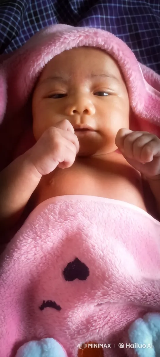 Baby in Cozy Pink Blanket on Dark Background – AI Generated Video | Hailuo AI