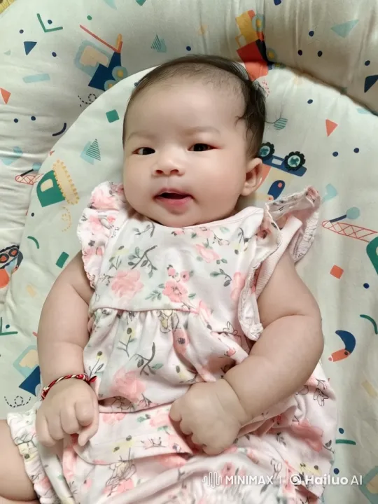 Baby Resting on Patterned Blanket in Floral Dress – AI Generated Video | Hailuo AI