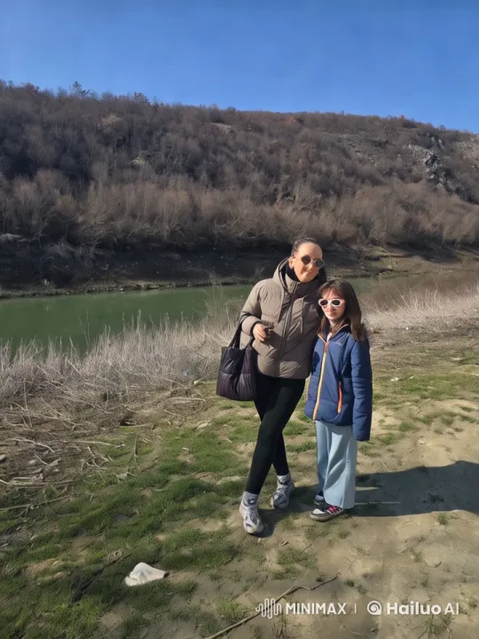 Woman and Girl Walk by River in Tranquil Landscape – AI Generated Video | Hailuo AI