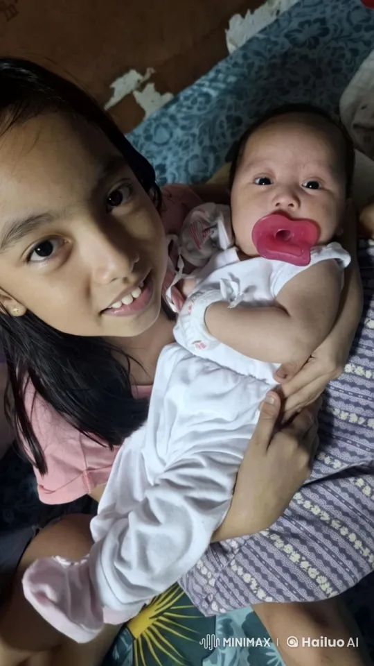 Sibling Bond: Baby Dancing Tenderly in Older Child's Arms – AI Generated Video | Hailuo AI