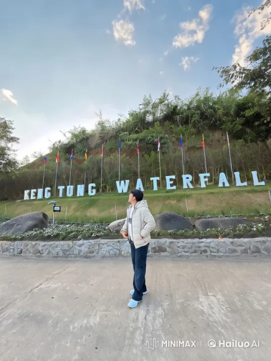 Keng Tung Waterfall: Person Mimics Flight in Scenic Landscape – AI Generated Video | Hailuo AI